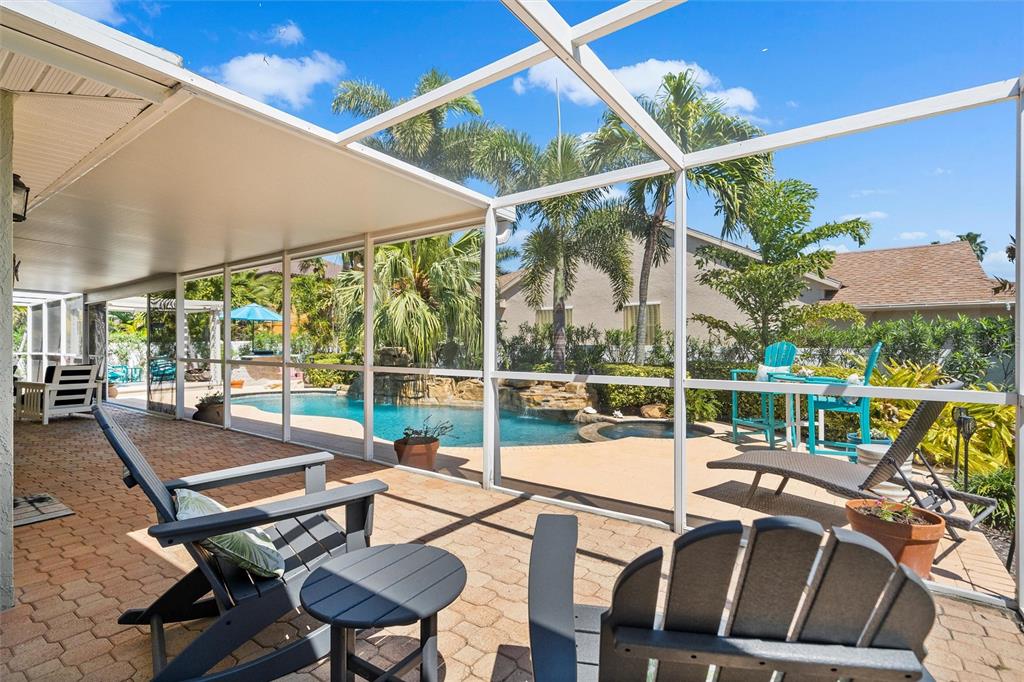 725 Monte Cristo Boulevard Tierra Verde, FL 33715 - Photo 14 of 63 a view of a patio with couches table and chairs and potted plants