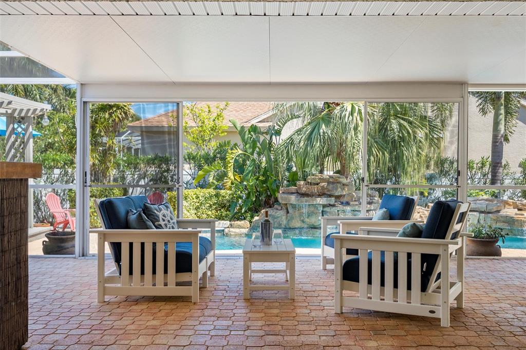 725 Monte Cristo Boulevard Tierra Verde, FL 33715 - Photo 18 of 63 a living room with furniture and a floor to ceiling window