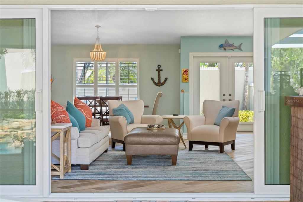 725 Monte Cristo Boulevard Tierra Verde, FL 33715 - Photo 20 of 63 a living room with furniture and a chandelier