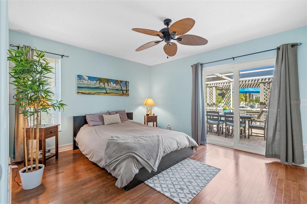 725 Monte Cristo Boulevard Tierra Verde, FL 33715 - Photo 22 of 63 a bedroom with a bed and a chandelier