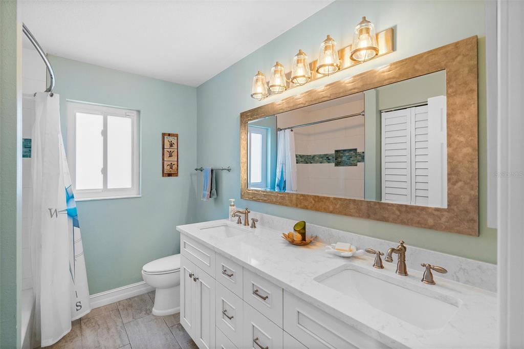 725 Monte Cristo Boulevard Tierra Verde, FL 33715 - Photo 24 of 63 a bathroom with a sink and a mirror