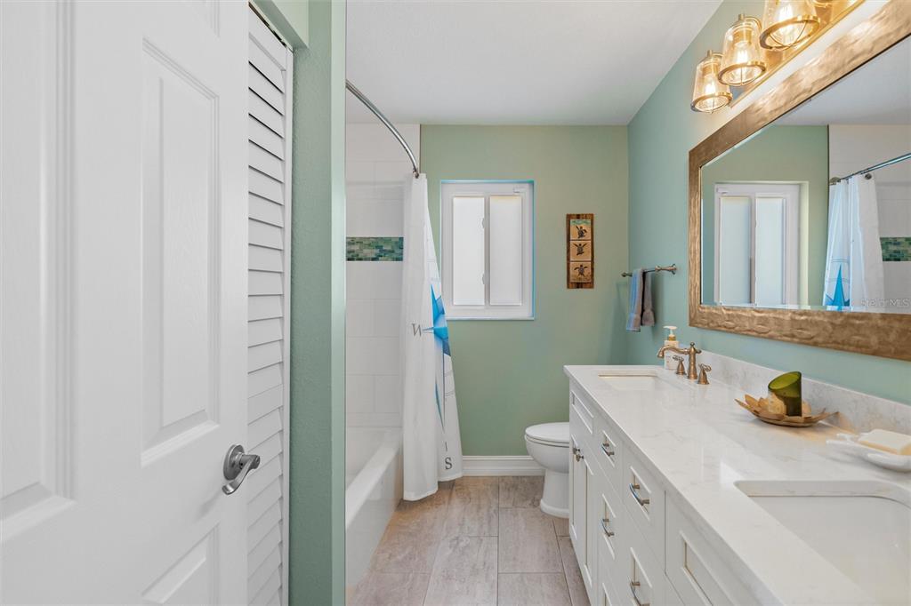 725 Monte Cristo Boulevard Tierra Verde, FL 33715 - Photo 27 of 63 a bathroom with a sink a toilet and a mirror