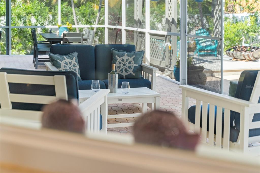 725 Monte Cristo Boulevard Tierra Verde, FL 33715 - Photo 28 of 63 a living room with couches and a floor to ceiling window