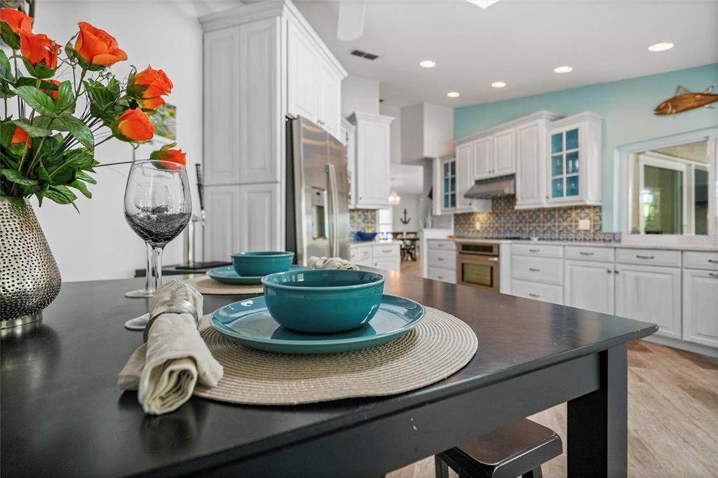 725 Monte Cristo Boulevard Tierra Verde, FL 33715 - Photo 30 of 63 a kitchen with a dining table and chairs