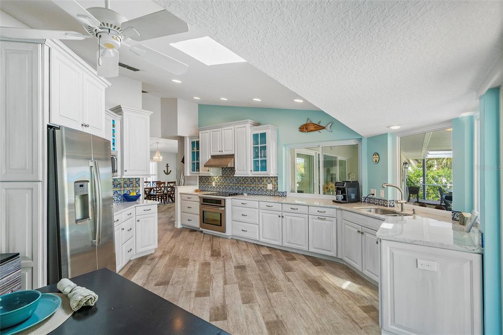 725 Monte Cristo Boulevard Tierra Verde, FL 33715 - Photo 35 of 63 a large kitchen with cabinets a counter top space stainless steel appliances and a counter space