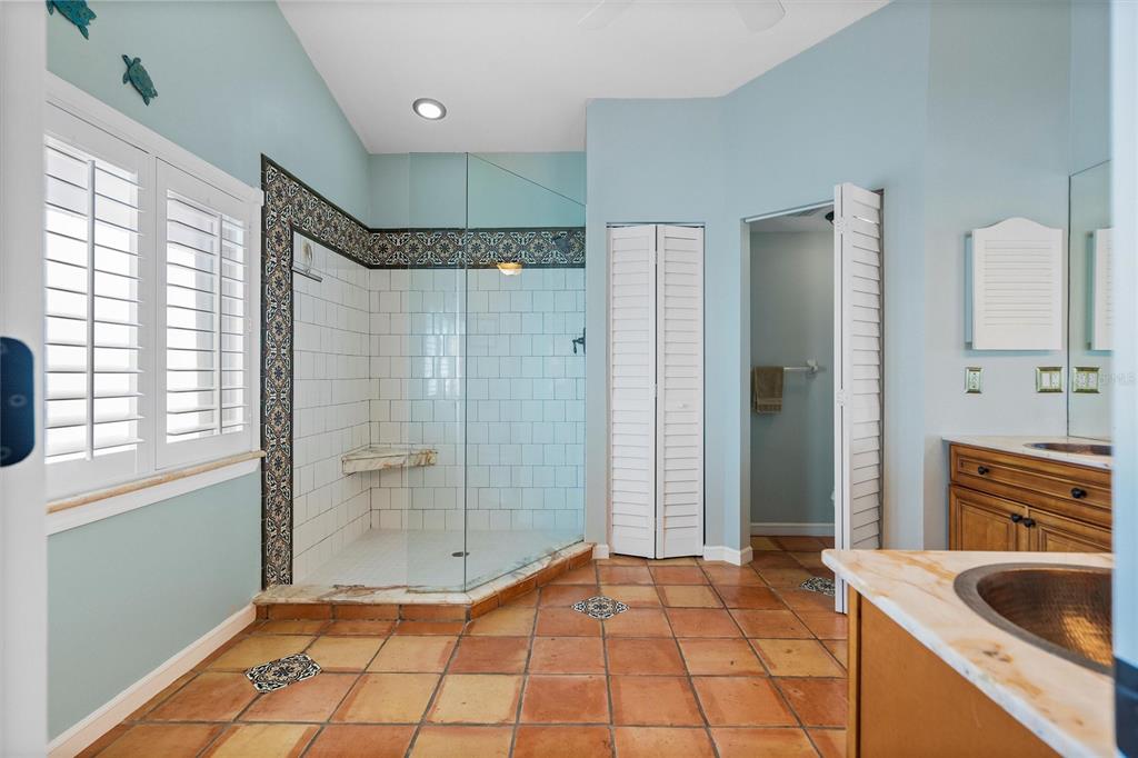 725 Monte Cristo Boulevard Tierra Verde, FL 33715 - Photo 36 of 63 a bathroom with a granite countertop sink a toilet and shower