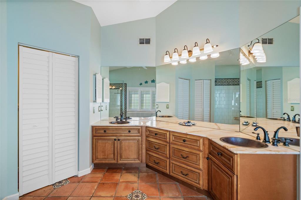 725 Monte Cristo Boulevard Tierra Verde, FL 33715 - Photo 37 of 63 a spacious bathroom with a double vanity sink a mirror and a bathtub