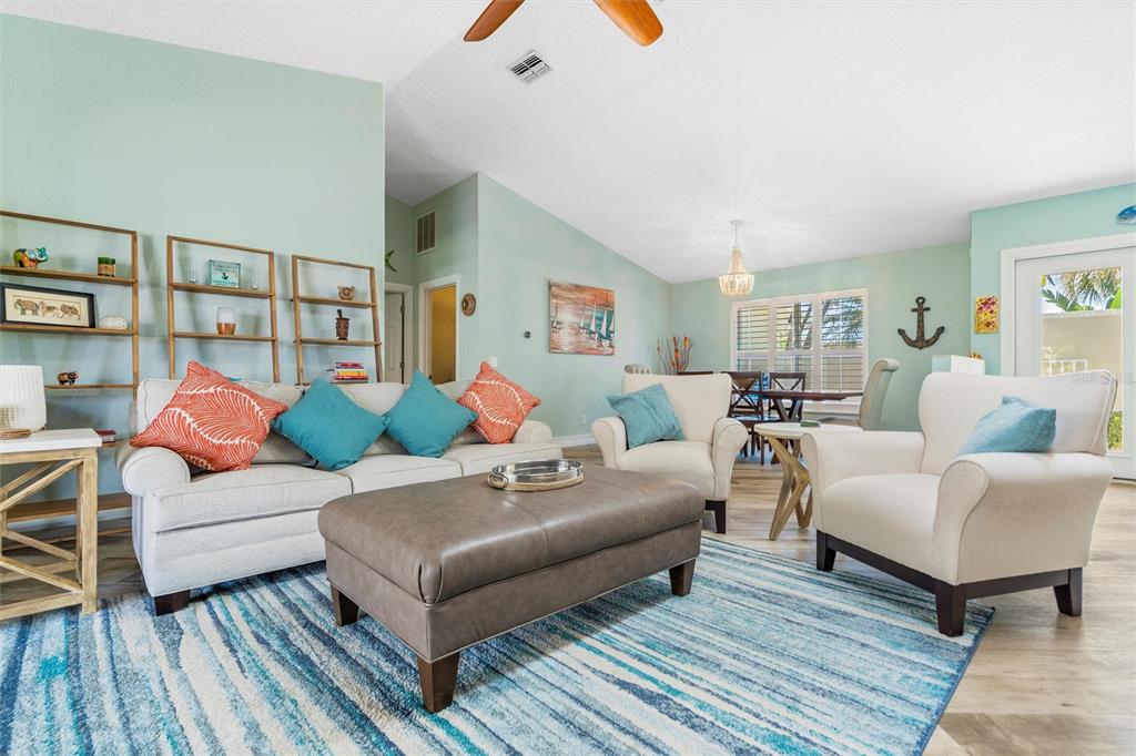 725 Monte Cristo Boulevard Tierra Verde, FL 33715 - Photo 40 of 63 a living room with furniture and a wooden floor