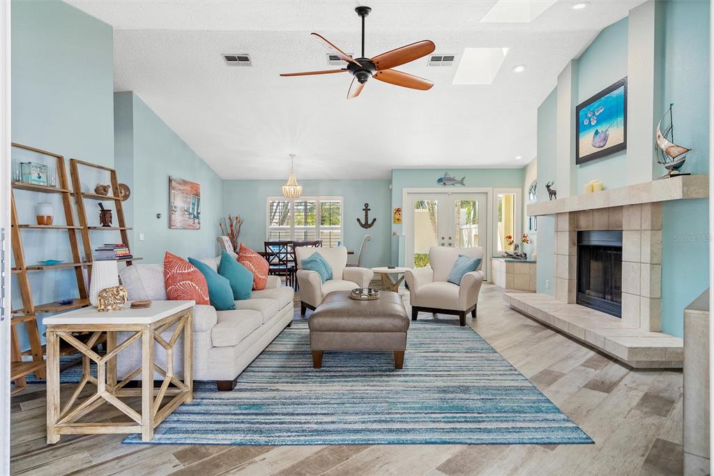 725 Monte Cristo Boulevard Tierra Verde, FL 33715 - Photo 42 of 63 a living room with furniture a rug and a fireplace