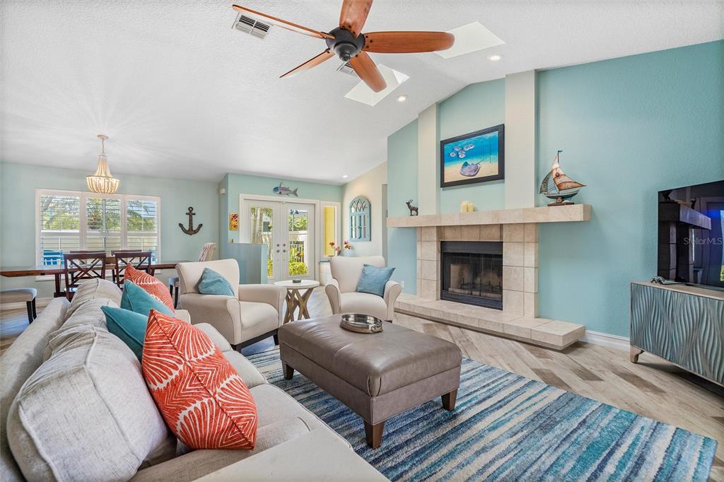 725 Monte Cristo Boulevard Tierra Verde, FL 33715 - Photo 43 of 63 a living room with furniture and a fireplace