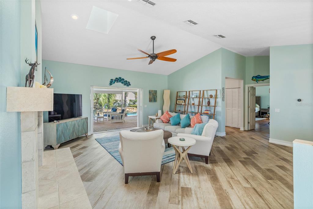 725 Monte Cristo Boulevard Tierra Verde, FL 33715 - Photo 45 of 63 a living room with furniture a rug and a chandelier