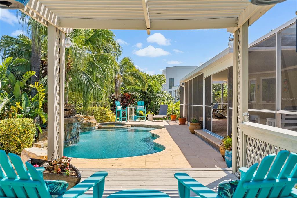 725 Monte Cristo Boulevard Tierra Verde, FL 33715 - Photo 6 of 63 a view of a patio with table and chairs potted plants with wooden floor