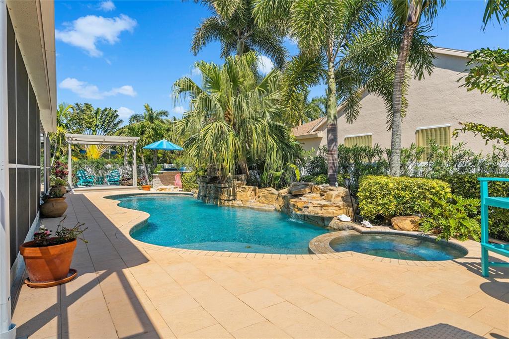 725 Monte Cristo Boulevard Tierra Verde, FL 33715 - Photo 9 of 63 a view of a swimming pool with a patio