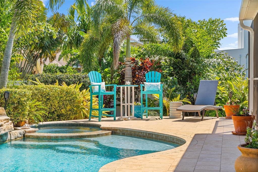 725 Monte Cristo Boulevard Tierra Verde, FL 33715 - Photo 10 of 63 a view of swimming pool with lawn chairs and plants