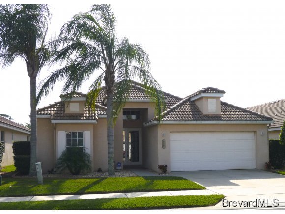 8225 Simpkins Way Melbourne, FL 32940 - Photo 1 of 12 a front view of a house with a yard and garage