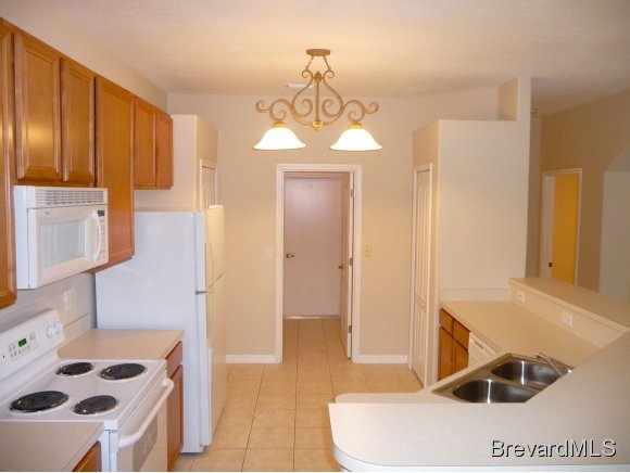 8225 Simpkins Way Melbourne, FL 32940 - Photo 6 of 12 a bathroom with a sink a toilet and mirror