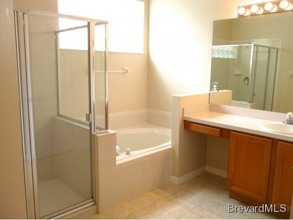 8225 Simpkins Way Melbourne, FL 32940 - Photo 9 of 12 a bathroom with a shower and a sink