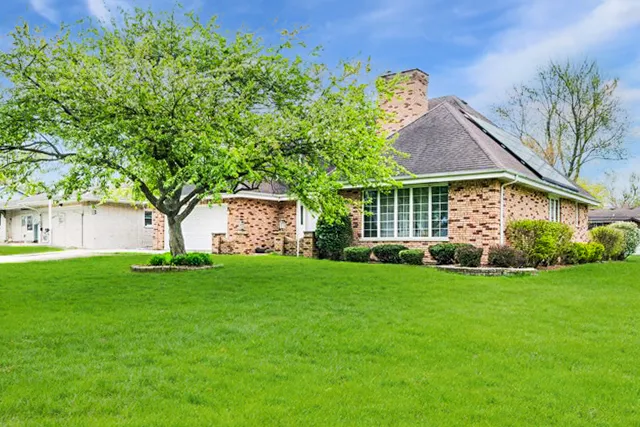 a view of a front of a house with a garden
