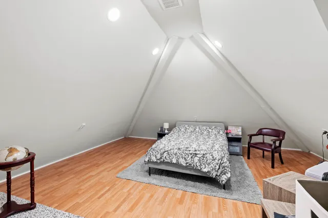 a bedroom with bed and a table