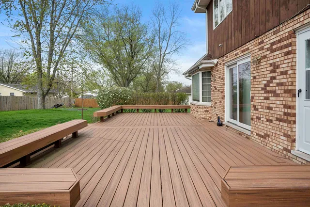 a view of backyard with deck and wooden floor