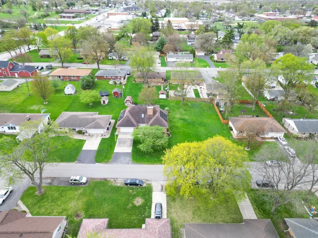 a view of a big house with a big yard and large tree