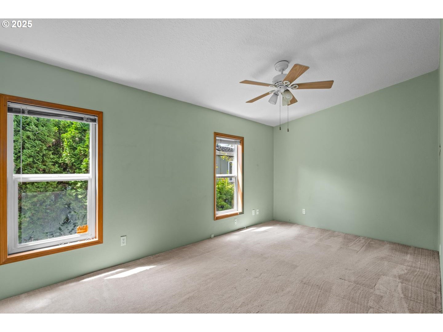 17629 Northwest Shady Fir Loop Beaverton, OR 97006 - Photo 13 of 27 a view of a room with a window and a ceiling fan