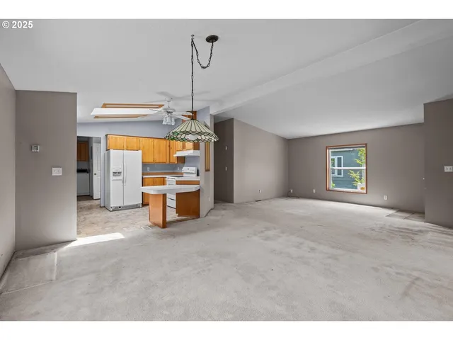 a view of a livingroom with a cabinet and chandelier