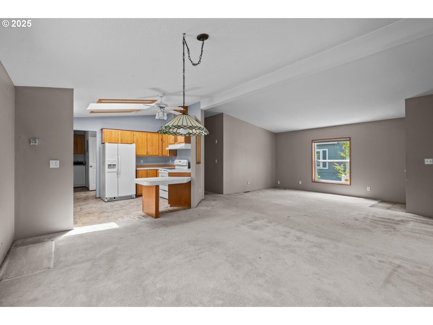 17629 Northwest Shady Fir Loop Beaverton, OR 97006 - Photo 6 of 27 a view of a livingroom with a cabinet and chandelier