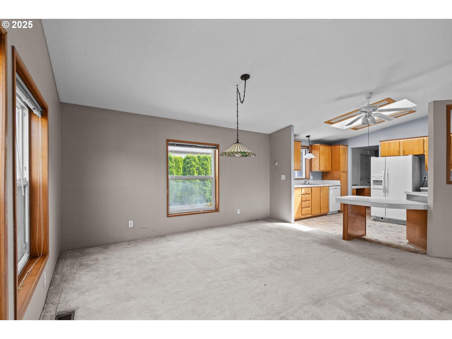 17629 Northwest Shady Fir Loop Beaverton, OR 97006 - Photo 7 of 27 a view of empty room with a window and chandelier