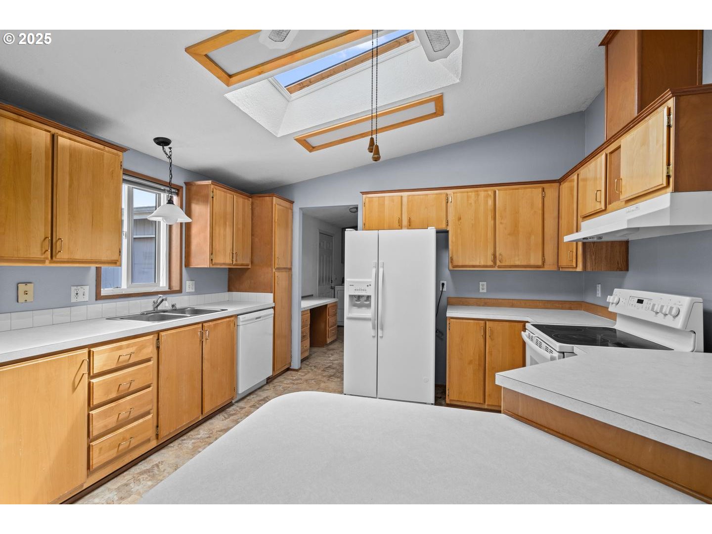 17629 Northwest Shady Fir Loop Beaverton, OR 97006 - Photo 8 of 27 a kitchen with refrigerator and cabinets