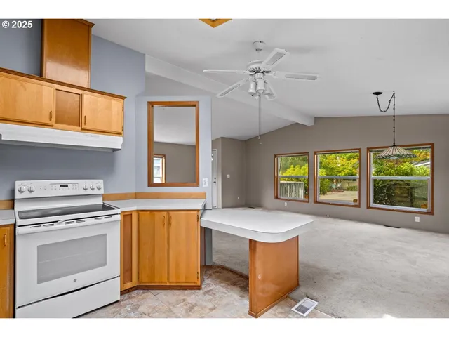 a kitchen with a stove a sink and a window
