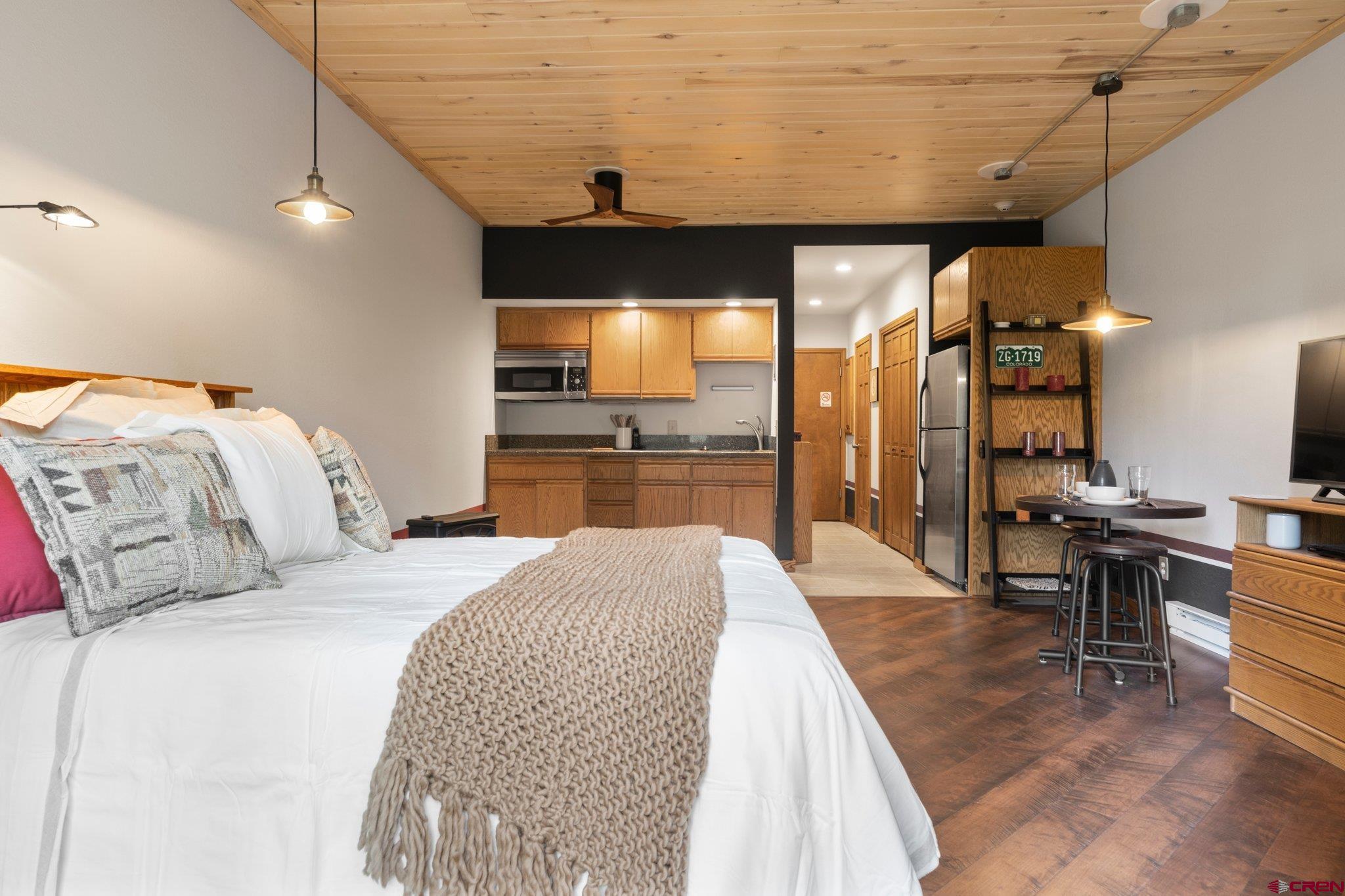 50827 Highway 550, Unit 339 Durango, CO 81301 - Photo 3 of 28 a bedroom with a bed and wooden floor