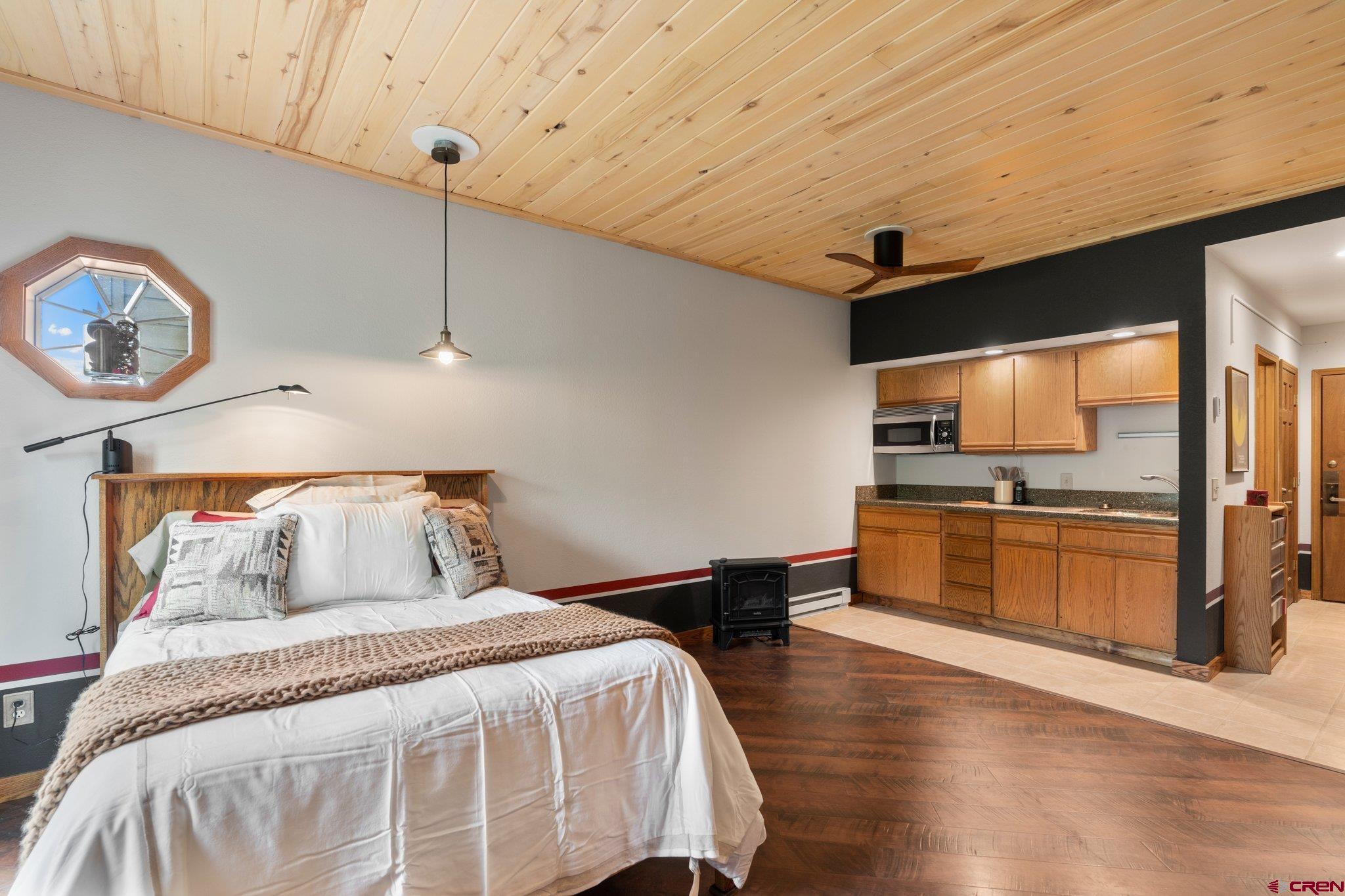 50827 Highway 550, Unit 339 Durango, CO 81301 - Photo 10 of 28 a bedroom with a large bed and a view of kitchen