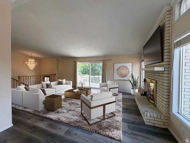 595 Meadowlark Road Orem, UT 84097 - Photo 2 of 88 Spacious living area featuring wood-finish flooring, a white brick fireplace with mantel, and sliding glass doors opening to a private deck