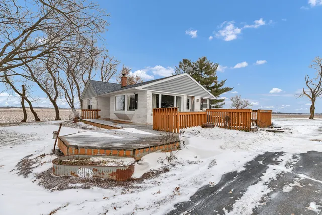 a view of a house with snow on the road