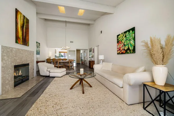 a living room with furniture a fireplace and a table