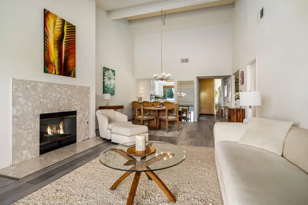 a living room with furniture a fireplace and a table