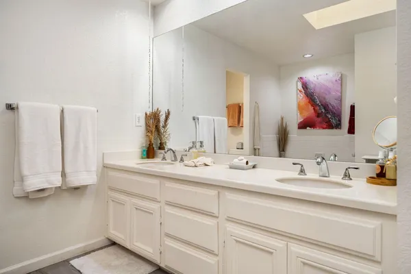 a bathroom with a double vanity sink and a mirror