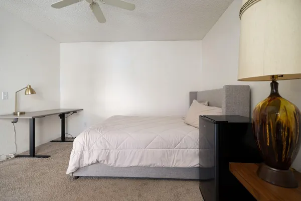 a bedroom with a bed and a lamp