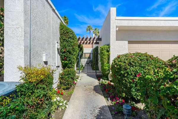 front view of a house with potted plants