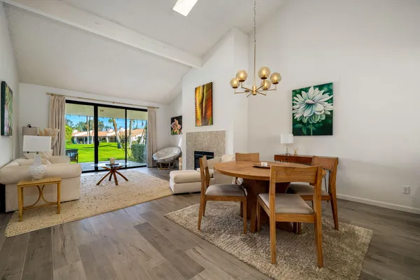 a living room with furniture a window and a chandelier