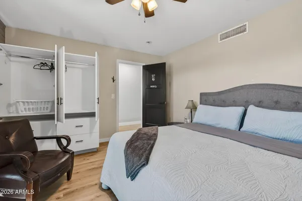 a bedroom with a bed couch and window