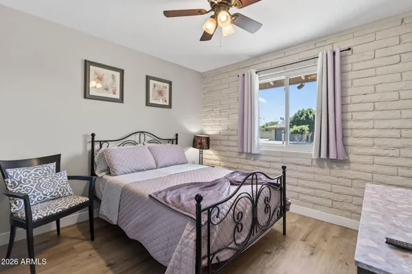 a spacious bedroom with a bed and window