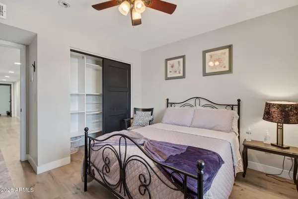 a bedroom with a bed and a chandelier