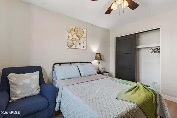 a bedroom with a bed and painting on the wall