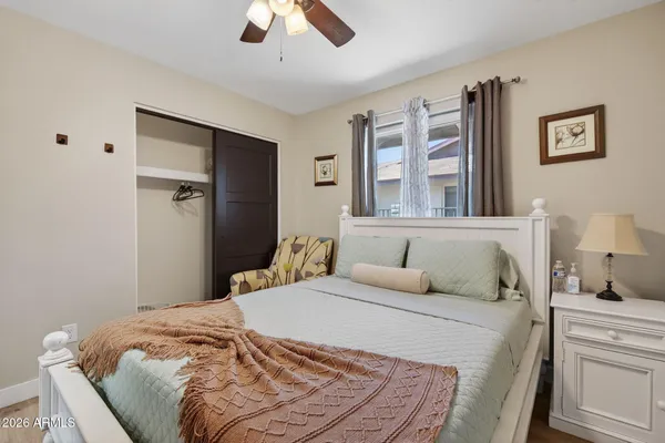 a bedroom with a large bed and a chandelier