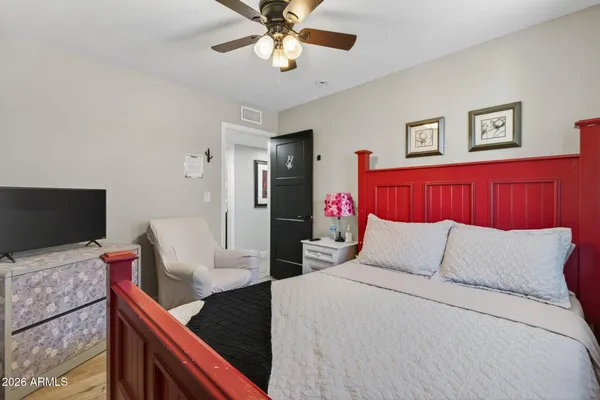 a bedroom with a bed and a flat screen tv