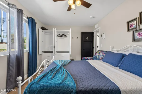 a bedroom with a large bed and a chandelier