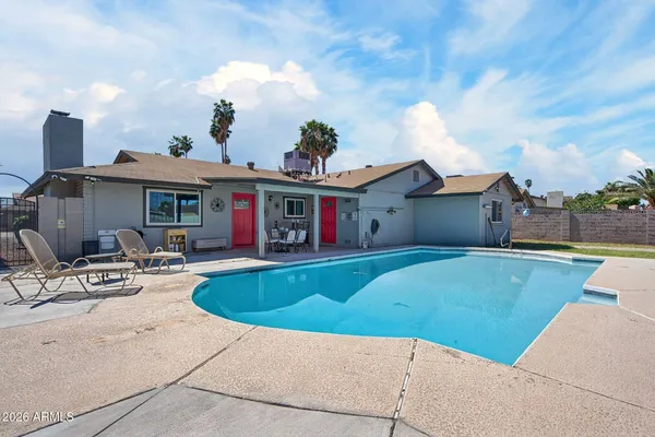 a view of a house with swimming pool and a sitting area
