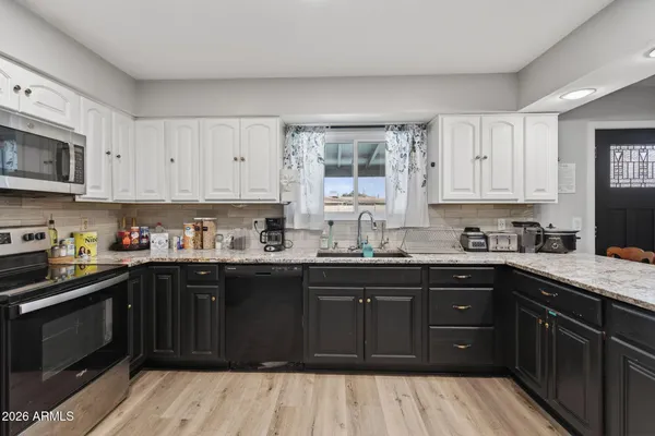 a kitchen with a sink stove and cabinets